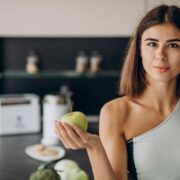 sporty woman with apple kitchen 1